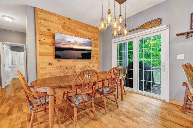 700 Pond Rd, Saint Albans, ME 04971 - dining room featuring light wood-style floors, wooden walls, and a chandelier