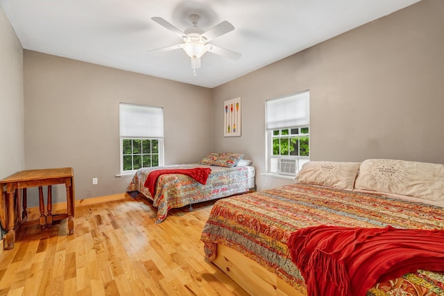 700 Pond Rd, Saint Albans, ME 04971 - bedroom featuring multiple windows, wood finished floors, cooling unit, and baseboards