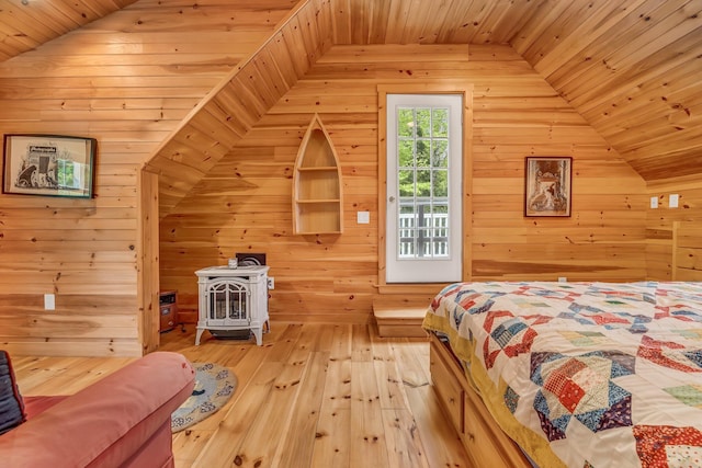 700 Pond Rd, Saint Albans, ME 04971 - bedroom with lofted ceiling, wood walls, a wood stove, light wood-type flooring, and wooden ceiling