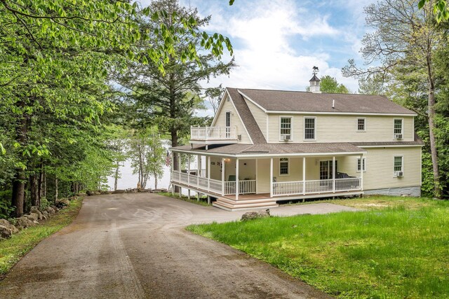 700 Pond Rd, Saint Albans, ME 04971 - view of front of home featuring a porch, asphalt driveway, a shingled roof, and a balcony