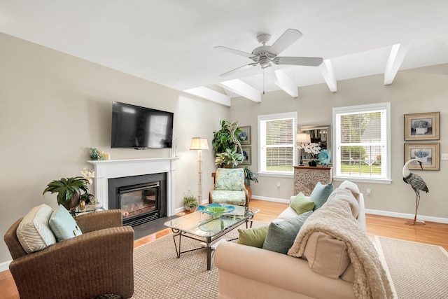 19 Winding Brook Ln S Unit 19, Wells, ME 04090 - living area with beamed ceiling, ceiling fan, a fireplace with flush hearth, light wood-style floors, and baseboards