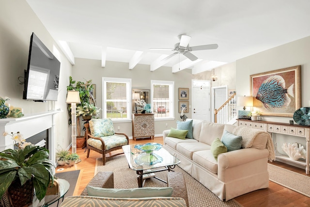 19 Winding Brook Ln S Unit 19, Wells, ME 04090 - living room featuring beamed ceiling, light wood-style floors, a fireplace with flush hearth, baseboards, and ceiling fan