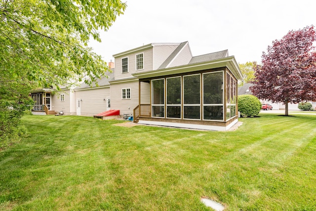 19 Winding Brook Ln S Unit 19, Wells, ME 04090 - rear view of house with a sunroom and a lawn