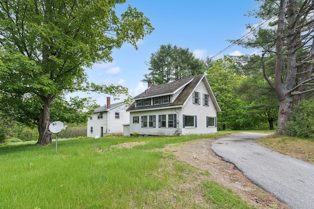 705707 Maine Ave, Farmingdale, ME 04344 - back of property with a chimney, asphalt driveway, and a shingled roof