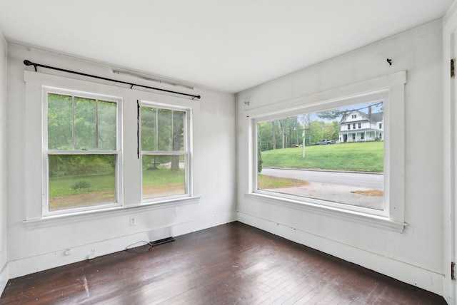 705707 Maine Ave, Farmingdale, ME 04344 - empty room featuring plenty of natural light, dark wood-type flooring, and baseboards