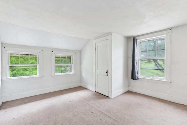 705707 Maine Ave, Farmingdale, ME 04344 - carpeted empty room featuring lofted ceiling, baseboards, and healthy amount of natural light