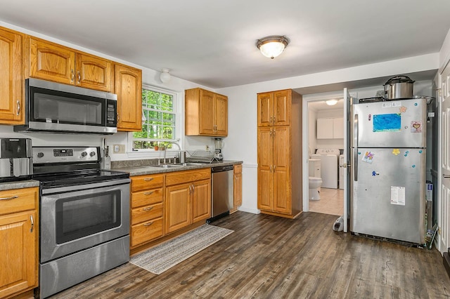 107 Tidy Rd Unit A & B, Eliot, ME 03903 - kitchen with stainless steel appliances, washer / dryer, a sink, and dark wood-style floors