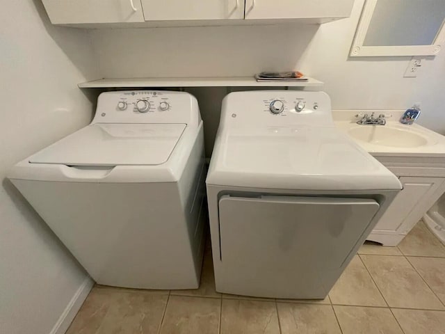 107 Tidy Rd Unit A & B, Eliot, ME 03903 - laundry room featuring washing machine and dryer, cabinet space, and light tile patterned flooring