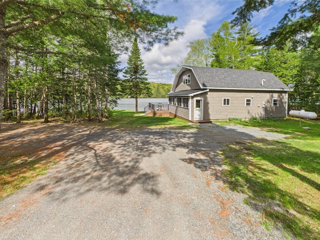 1107 S Shore Rd, Madawaska Lake Twp, ME 04783 - view of home's exterior with a gambrel roof and a yard