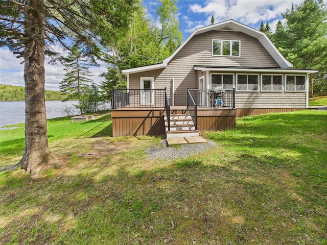 1107 S Shore Rd, Madawaska Lake Twp, ME 04783 - rear view of house featuring a deck with water view, a yard, and a sunroom