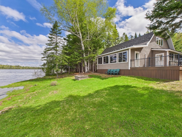1107 S Shore Rd, Madawaska Lake Twp, ME 04783 - view of grassy yard with a deck with water view