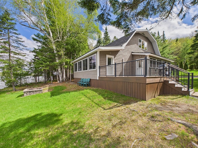 1107 S Shore Rd, Madawaska Lake Twp, ME 04783 - view of side of home featuring stairs, an outdoor fire pit, a yard, and a deck