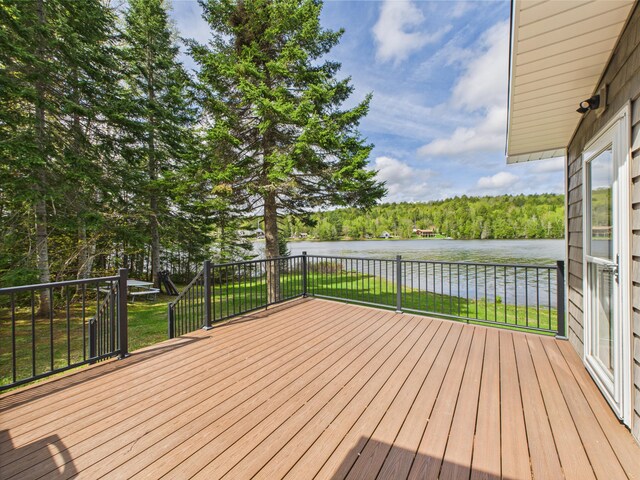 1107 S Shore Rd, Madawaska Lake Twp, ME 04783 - deck with a water view, a lawn, and a forest view