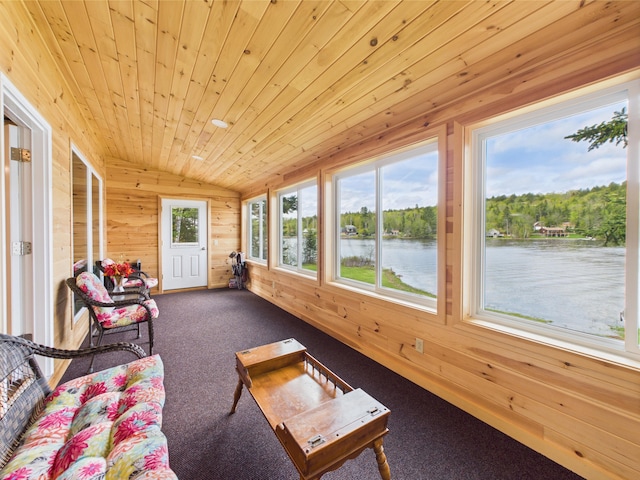 1107 S Shore Rd, Madawaska Lake Twp, ME 04783 - sunroom featuring vaulted ceiling, wood walls, a water view, carpet flooring, and wooden ceiling