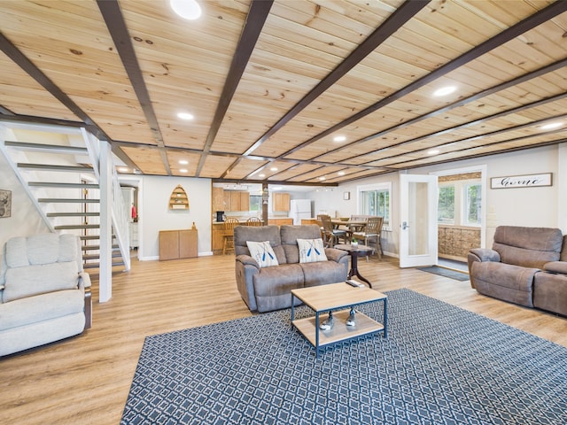 1107 S Shore Rd, Madawaska Lake Twp, ME 04783 - living area featuring light wood-style floors, stairway, wood ceiling with exposed beams, baseboards, and recessed lighting