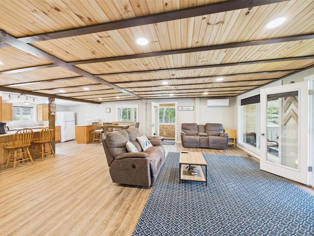 1107 S Shore Rd, Madawaska Lake Twp, ME 04783 - living area with a wall mounted air conditioner, french doors, light wood-style flooring, recessed lighting, and wood ceiling with exposed beams