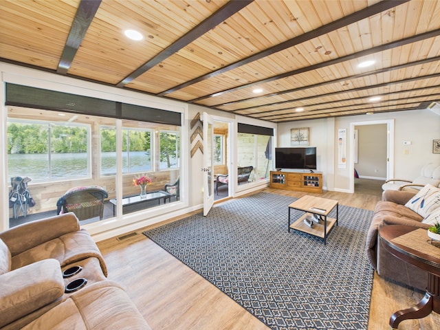 1107 S Shore Rd, Madawaska Lake Twp, ME 04783 - living room with wood finished floors, wooden ceiling with exposed beams, baseboards, and recessed lighting