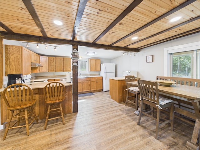 1107 S Shore Rd, Madawaska Lake Twp, ME 04783 - dining area featuring light wood-type flooring and wood ceiling with exposed beams