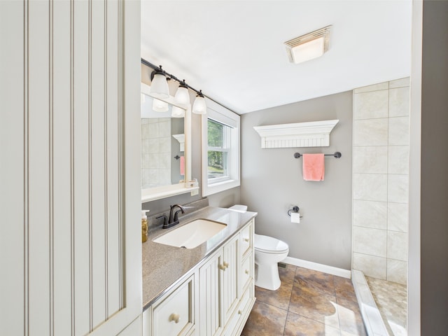 1107 S Shore Rd, Madawaska Lake Twp, ME 04783 - bathroom with toilet, vanity, baseboards, and tiled shower