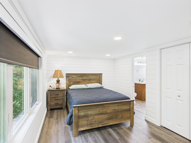 1107 S Shore Rd, Madawaska Lake Twp, ME 04783 - bedroom with wood finished floors, connected bathroom, and recessed lighting