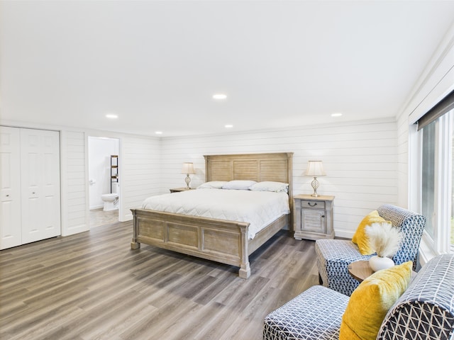 1107 S Shore Rd, Madawaska Lake Twp, ME 04783 - bedroom with wood finished floors, recessed lighting, ensuite bathroom, and wooden walls