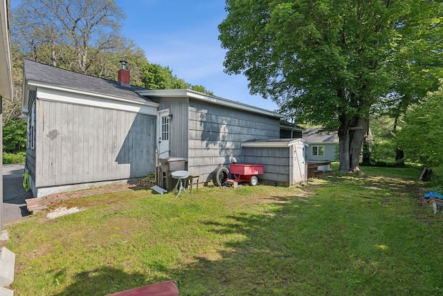 83 E Cote St, Lewiston, ME 04240 - back of property featuring a lawn and a chimney