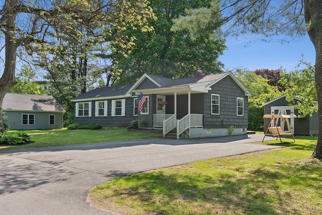 83 E Cote St, Lewiston, ME 04240 - ranch-style house featuring a porch, a chimney, asphalt driveway, and a front yard