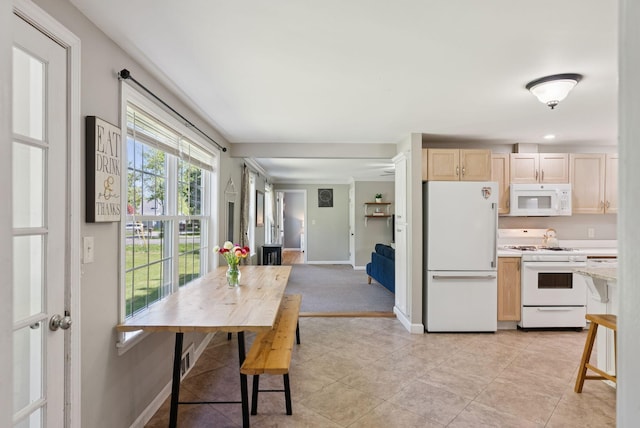 83 E Cote St, Lewiston, ME 04240 - kitchen with white appliances, light brown cabinets, baseboards, and light tile patterned flooring
