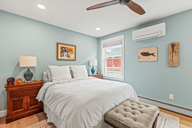 15 Pacer Way, Scarborough, ME 04074 - bedroom featuring a wall unit AC, baseboard heating, wood finished floors, a ceiling fan, and recessed lighting