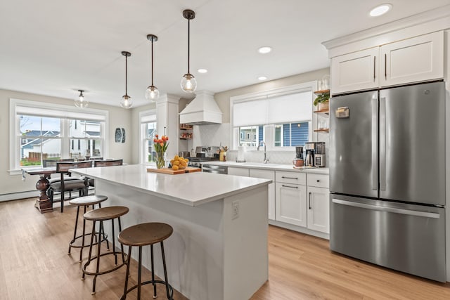 15 Pacer Way, Scarborough, ME 04074 - kitchen with stainless steel appliances, custom range hood, healthy amount of natural light, a center island, and recessed lighting