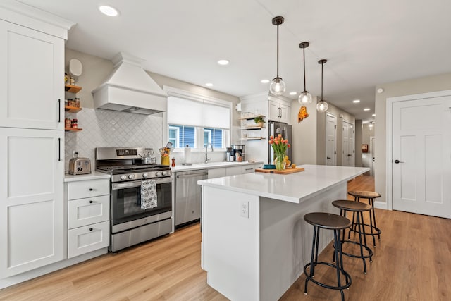 15 Pacer Way, Scarborough, ME 04074 - kitchen featuring stainless steel appliances, open shelves, custom exhaust hood, a breakfast bar area, and white cabinetry