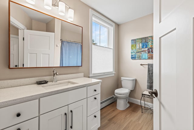 15 Pacer Way, Scarborough, ME 04074 - full bath with baseboard heating, toilet, vanity, wood finished floors, and baseboards