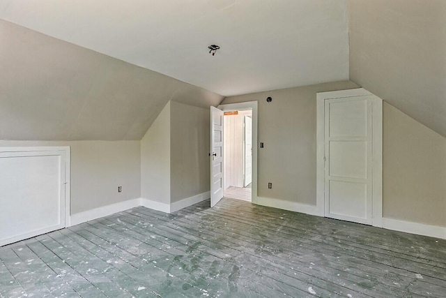 2 Elm Ter, Waterville, ME 04901 - additional living space with lofted ceiling, baseboards, and wood finished floors