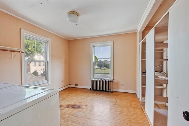 2 Elm Ter, Waterville, ME 04901 - spare room with radiator heating unit, light wood finished floors, crown molding, washing machine and dryer, and baseboards