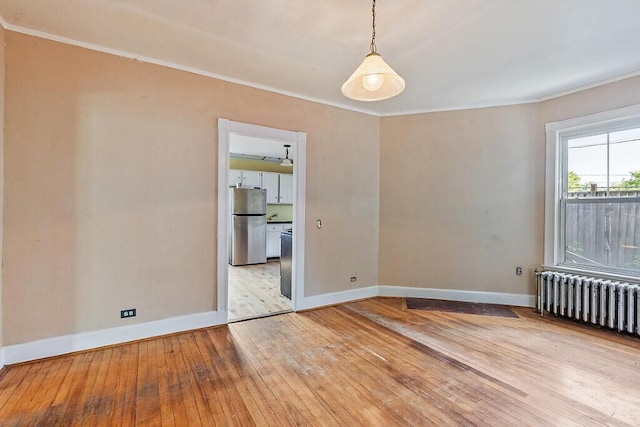 2 Elm Ter, Waterville, ME 04901 - unfurnished room featuring wood-type flooring, radiator heating unit, baseboards, and crown molding