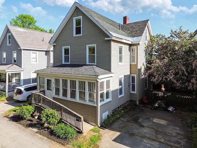 2 Elm Ter, Waterville, ME 04901 - view of front of house with stairway, a chimney, and a shingled roof