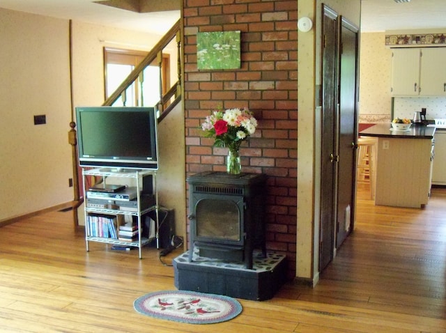 593 S Strong Rd, Strong, ME 04983 - living area with light wood-style flooring and a wood stove