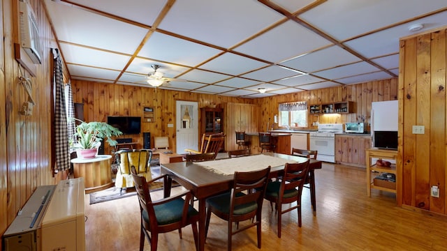 574 Scribner Hill Rd, Otisfield, ME 04270 - dining space with wooden walls, a ceiling fan, and light wood finished floors