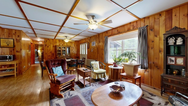 574 Scribner Hill Rd, Otisfield, ME 04270 - living area with wood walls, wood finished floors, and a ceiling fan