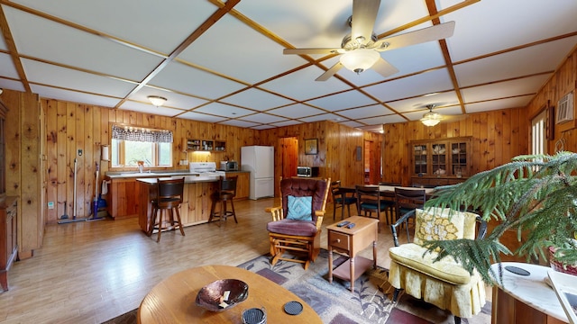 574 Scribner Hill Rd, Otisfield, ME 04270 - living area with wooden walls, light wood finished floors, and ceiling fan