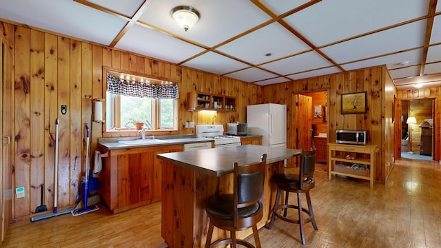 574 Scribner Hill Rd, Otisfield, ME 04270 - kitchen featuring white appliances, a sink, wooden walls, light wood-style flooring, and brown cabinets