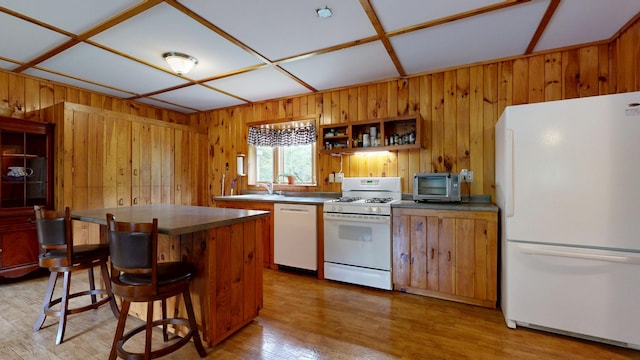 574 Scribner Hill Rd, Otisfield, ME 04270 - kitchen with white appliances, wood walls, light wood-style flooring, open shelves, and a kitchen bar