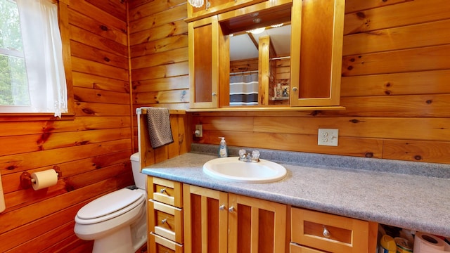 574 Scribner Hill Rd, Otisfield, ME 04270 - bathroom featuring toilet, vanity, wood walls, and a shower with shower curtain