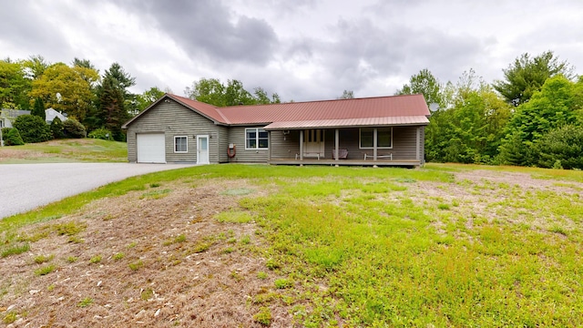 574 Scribner Hill Rd, Otisfield, ME 04270 - single story home with an attached garage, a porch, metal roof, and driveway