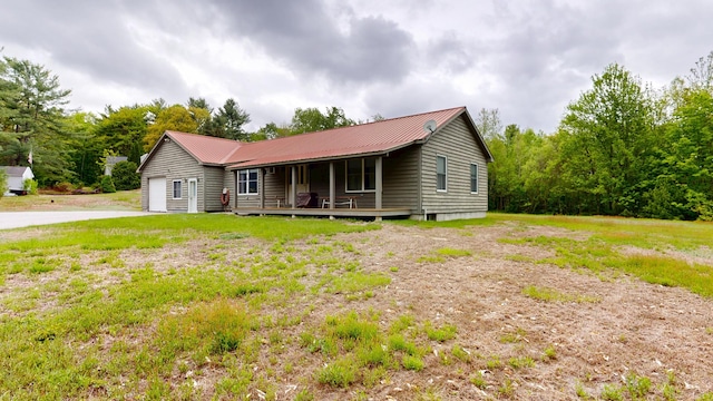 574 Scribner Hill Rd, Otisfield, ME 04270 - ranch-style home with a porch, a garage, metal roof, driveway, and a front yard