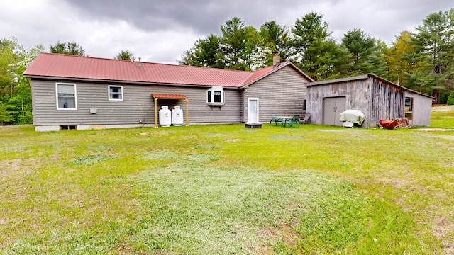 574 Scribner Hill Rd, Otisfield, ME 04270 - rear view of property featuring a yard, metal roof, a chimney, and an outdoor structure