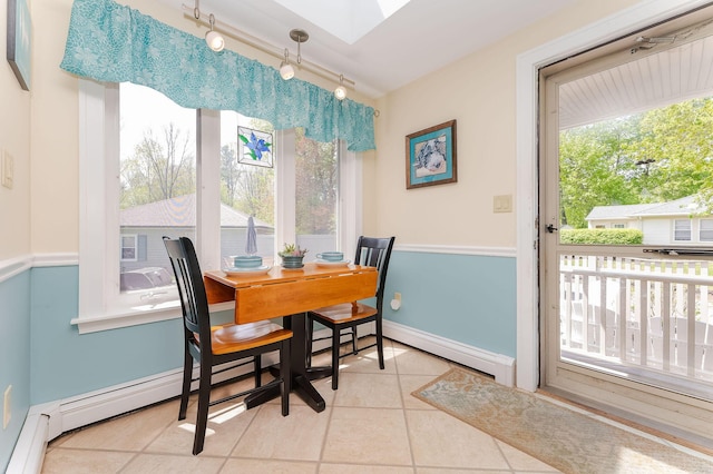5 Nash Pkwy, Somersworth, NH 03878 - dining space with tile patterned floors, a skylight, track lighting, baseboards, and baseboard heating