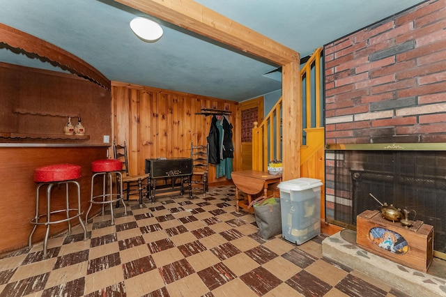 5 Nash Pkwy, Somersworth, NH 03878 - living area featuring tile patterned floors, wooden walls, a fireplace, and stairs