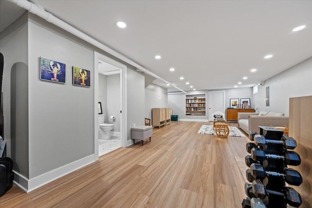 4 Frontrunner Way, Scarborough, ME 04074 - living area featuring light wood finished floors, recessed lighting, arched walkways, and baseboards