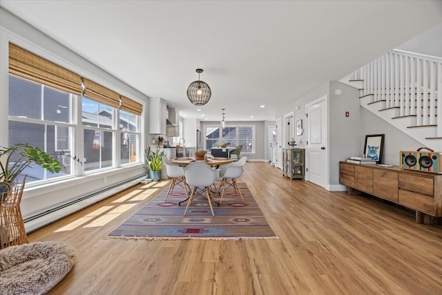 4 Frontrunner Way, Scarborough, ME 04074 - dining space featuring a baseboard radiator, a chandelier, light wood-type flooring, stairway, and baseboards